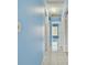 Bright hallway with light blue walls and tile floors at 10323 Del Mar Cir, Tampa, FL 33624