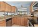 Bright kitchen with wood cabinets and granite counters at 10323 Del Mar Cir, Tampa, FL 33624