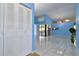 Open living room with tiled floors and blue walls at 10323 Del Mar Cir, Tampa, FL 33624