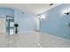 Bright living area featuring tile floors and light blue walls at 10323 Del Mar Cir, Tampa, FL 33624