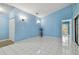 Light and airy living room with tile floors and light blue walls at 10323 Del Mar Cir, Tampa, FL 33624