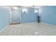 Spacious living room with tiled floors and light blue walls at 10323 Del Mar Cir, Tampa, FL 33624
