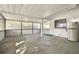 Covered patio with concrete floor, screen enclosure, and mini fridge at 10323 Del Mar Cir, Tampa, FL 33624