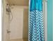 Simple shower stall with teal chevron shower curtain at 10323 Del Mar Cir, Tampa, FL 33624