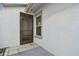 Side entrance with screen door and window, showing exterior details at 10323 Del Mar Cir, Tampa, FL 33624