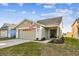 House exterior showcasing a two-car garage and landscaping at 10608 Lakeside Vista Dr, Riverview, FL 33569