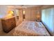 Spacious bedroom with a queen bed and dresser at 12501 Ulmerton Rd # 188, Largo, FL 33774