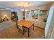 Simple dining area with wood floors and view into kitchen at 12501 Ulmerton Rd # 188, Largo, FL 33774