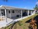 Mobile home with covered patio, landscaped yard, and carport at 12501 Ulmerton Rd # 188, Largo, FL 33774