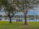 Serene lake view with a quiet bench for relaxation at 12501 Ulmerton Rd # 188, Largo, FL 33774