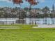 Peaceful lakefront view with benches and grassy area at 12501 Ulmerton Rd # 188, Largo, FL 33774