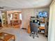 Open living space with home office and view into dining area at 12501 Ulmerton Rd # 188, Largo, FL 33774