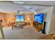 Living room with sofa, coffee table, and large TV at 12501 Ulmerton Rd # 188, Largo, FL 33774
