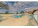 Community pool with lounge chairs and a fenced area at 12501 Ulmerton Rd # 188, Largo, FL 33774