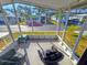 Relaxing screened porch with wicker furniture and view of community at 12501 Ulmerton Rd # 188, Largo, FL 33774