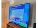Large flat-screen TV displaying financial news at 12501 Ulmerton Rd # 188, Largo, FL 33774