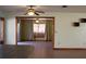 Open kitchen featuring wood cabinets, black appliances, tile backsplash, and view of adjacent living spaces at 1322 Kenmore St, Port Charlotte, FL 33952