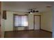 Inviting living room with tile flooring, bright window, ceiling fan, and traditional front door at 1322 Kenmore St, Port Charlotte, FL 33952
