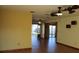 Open living room showcasing neutral walls, tile flooring, multiple ceiling fans, and natural light throughout at 1322 Kenmore St, Port Charlotte, FL 33952