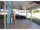 Screened patio featuring tile flooring, ceiling fan, and backyard views at 1322 Kenmore St, Port Charlotte, FL 33952