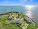 Aerial view of waterfront condo community with tennis courts and pool at 134 Mariner Dr # 134, Tarpon Springs, FL 34689