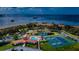 Aerial view of community pool, tennis and pickleball courts at 134 Mariner Dr # 134, Tarpon Springs, FL 34689