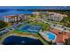 Aerial view of community pool, tennis and pickleball courts at 134 Mariner Dr # 134, Tarpon Springs, FL 34689