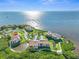 Aerial view of waterfront condo community with tennis courts and pool at 134 Mariner Dr # 134, Tarpon Springs, FL 34689