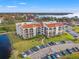 Aerial view of waterfront condo building with parking and water access at 134 Mariner Dr # 134, Tarpon Springs, FL 34689