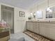 Double vanity bathroom with granite countertops and linen closet at 134 Mariner Dr # 134, Tarpon Springs, FL 34689