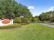 Mariner Village Tarpon Cove entrance, lush landscaping and a paved road at 134 Mariner Dr # 134, Tarpon Springs, FL 34689