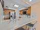 Kitchen with wood cabinets, white appliances, and tile floors at 134 Mariner Dr # 134, Tarpon Springs, FL 34689
