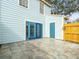 Back patio with blue doors and access to storage at 13817 Stone Mill Way, Tampa, FL 33613