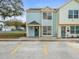 Front view of a two-story townhome with a blue and yellow exterior at 13817 Stone Mill Way, Tampa, FL 33613