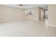 Open living area with a kitchen pass-through and tile flooring at 13817 Stone Mill Way, Tampa, FL 33613