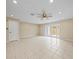 Living room with tile floors, ceiling fan, and patio doors at 13817 Stone Mill Way, Tampa, FL 33613