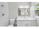 Modern bathroom with white cabinets, marble shower, and quartz countertop at 1399 Grapeleaf Ct, Tarpon Springs, FL 34689