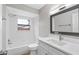 Clean bathroom with white vanity, bathtub, and window at 1399 Grapeleaf Ct, Tarpon Springs, FL 34689