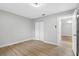 Simple bedroom with light gray walls and wood-look floors at 1399 Grapeleaf Ct, Tarpon Springs, FL 34689