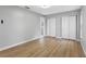 Bright bedroom with double door closet and wood-look flooring at 1399 Grapeleaf Ct, Tarpon Springs, FL 34689