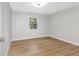 Bright bedroom with light gray walls and wood-look flooring at 1399 Grapeleaf Ct, Tarpon Springs, FL 34689