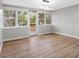 Bright dining room with view to backyard and wood-look flooring at 1399 Grapeleaf Ct, Tarpon Springs, FL 34689