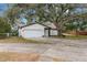 House exterior with driveway and large shade tree at 1399 Grapeleaf Ct, Tarpon Springs, FL 34689