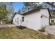 House exterior with garage and side yard landscaping at 1399 Grapeleaf Ct, Tarpon Springs, FL 34689