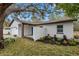 Side view of house showcasing landscaping and garage at 1399 Grapeleaf Ct, Tarpon Springs, FL 34689