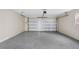 Spacious garage with epoxy flooring and an overhead door at 1399 Grapeleaf Ct, Tarpon Springs, FL 34689