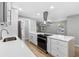 Modern kitchen with stainless steel appliances and breakfast bar at 1399 Grapeleaf Ct, Tarpon Springs, FL 34689