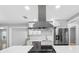 Modern kitchen with stainless steel appliances and breakfast bar at 1399 Grapeleaf Ct, Tarpon Springs, FL 34689