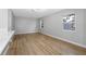 Bright living room featuring light walls and wood-look floors at 1399 Grapeleaf Ct, Tarpon Springs, FL 34689