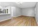Bright living room with light gray walls and wood-look flooring at 1399 Grapeleaf Ct, Tarpon Springs, FL 34689